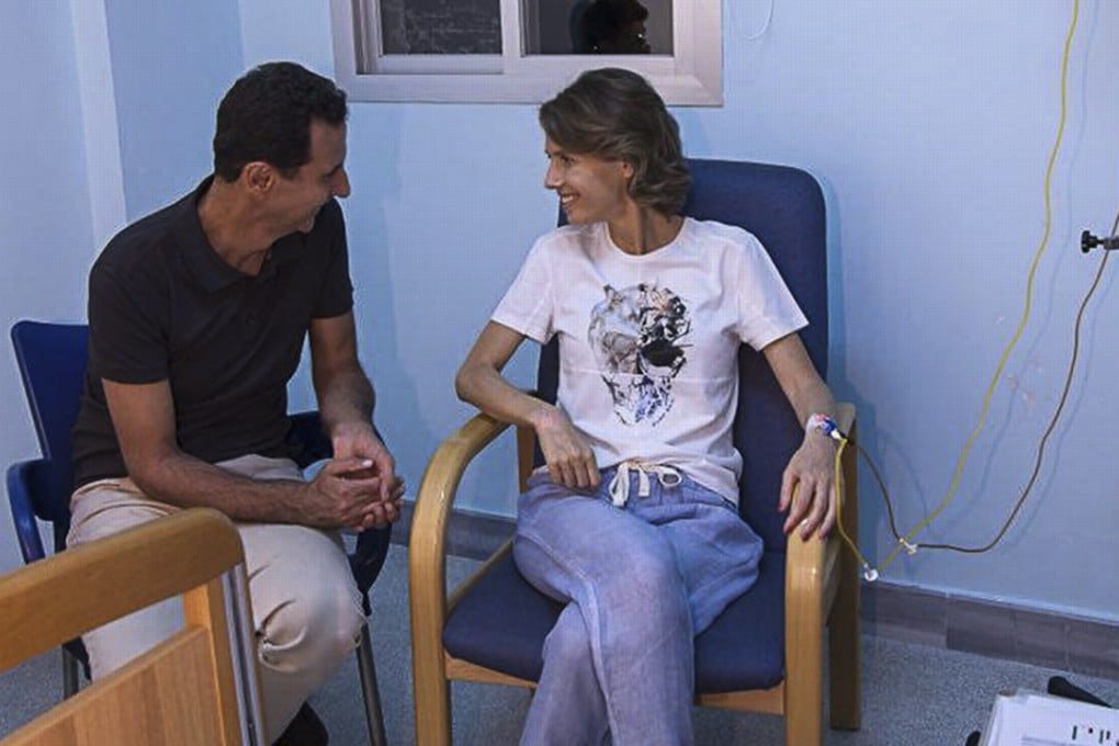 Syrian President Bashar Al-Assad sit next to his wife Asmaa al-Assad as she apparently receives cancer treatment at a military hospital in Damascus, in a photo released by the presidential office. Photo: EPA