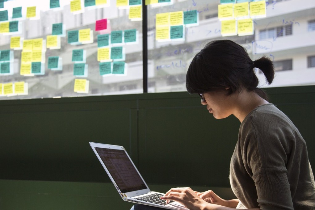 An employee works on a laptop computer at the Carousell headquarters in Singapore. Six-year-old Carousell operates in seven markets including Singapore, Hong Kong and Australia and is one of the region's most popular virtual flea markets. The city state is said by start-ups and advisers to hold the upper hand on Hong Kong as a place to build a business, with access to funding remaining a challenge in the latter. Photo: Bloomberg