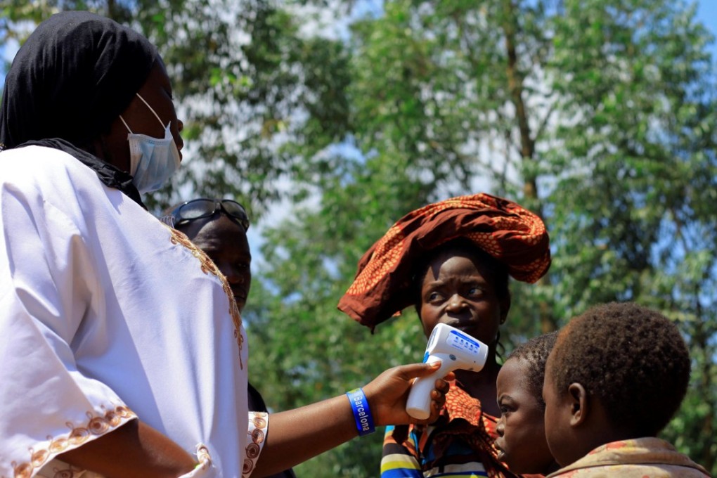A Congolese health worker checks the temperature of a child before the launch of vaccination campaign against the deadly Ebola virus near Mangina village, near the town of Beni, in North Kivu province of the Democratic Republic of Congo on Wednesday. Photo: Reuters