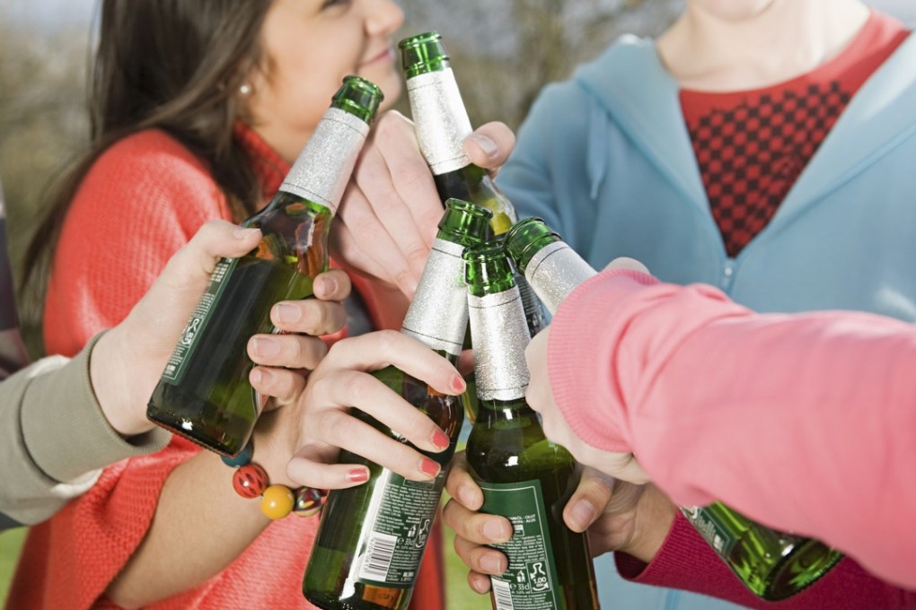 Teens with beer bottles. Retail outlets across Hong Kong, not just restaurants, will soon be prohibited from selling alcoholic beverages to minors. Photo: Image Source/Corbis
