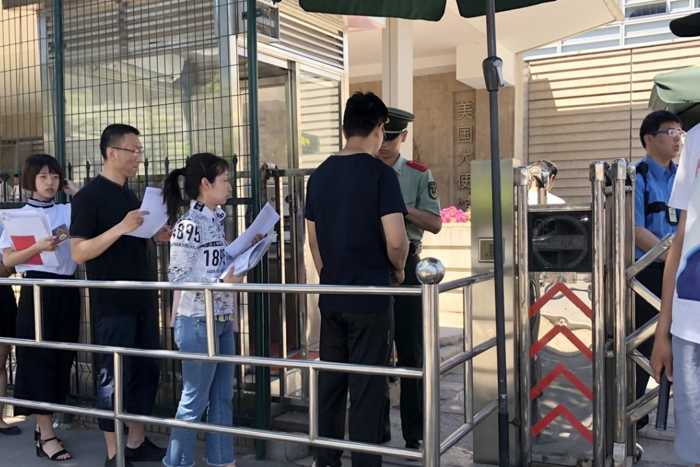Chinese citizens line up for visa interviews outside the US embassy in Beijing. Photo: Simon Song