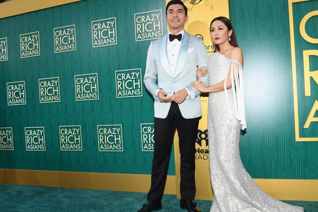 Henry Golding and Constance Wu arrive at the red carpet. Wu wears a look from Ralph & Russo. Photo: AFP