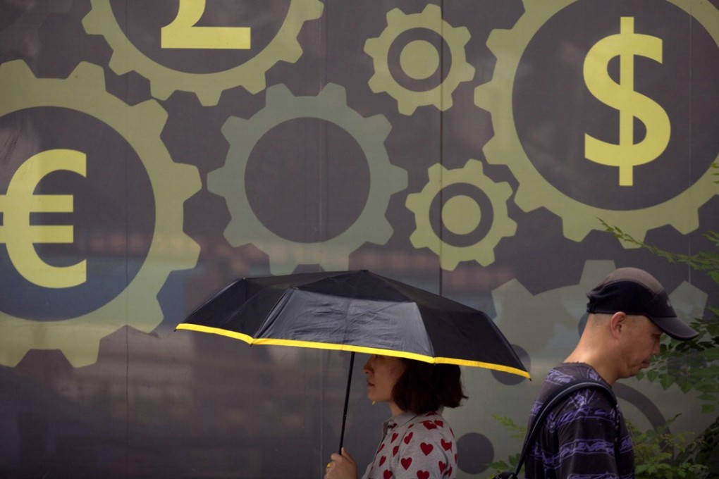 A mural displaying world currency symbols on the outside of a bank in Beijing. The fall of the yuan has been the subject of much concern online. Photo: AP