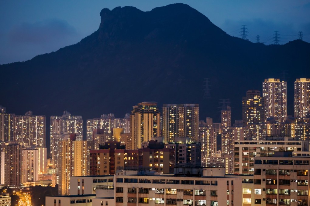 Residential buildings stand illuminated in Hong Kong. The cost of owning a home in Hong Kong will go up after most banks in the city said they are raising their mortgage rates. Photo: Bloomberg