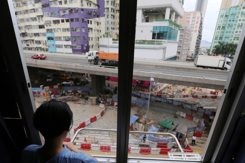 Lily Yeung looks out at the construction in To Kwa Wan which has affected nearby residential buildings. Photo: Dickson Lee