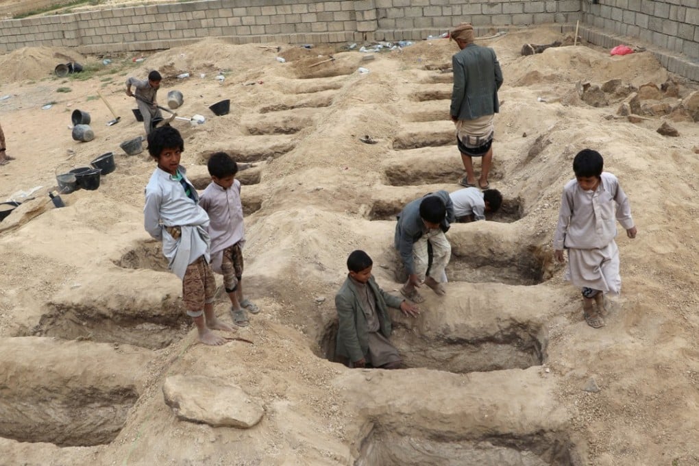 Boys inspect graves prepared for victims of Thursday's Saudi-led coalition air strike in Saada province, Yemen. Photo: Reuters