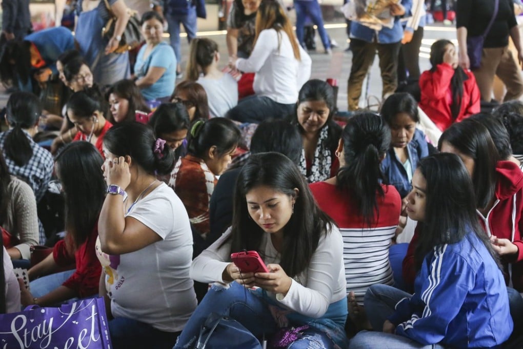 Hong Kong has about 380,000 foreign domestic workers, with about half coming from the Philippines[...]. Photo: Dickson Lee