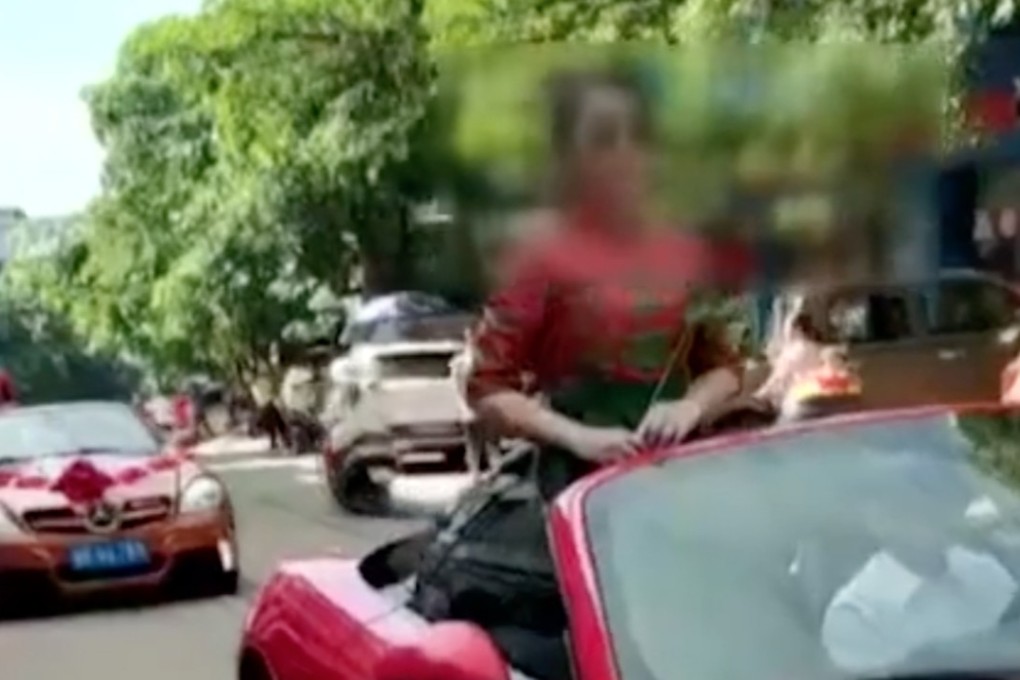 The women are seen in the video in a slow-moving convoy of convertibles, dressed in red cheongsam. Photo: Thepaper.cn