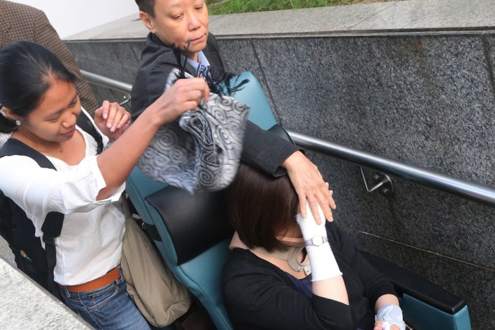Former civil servant Au Wai-chun (in wheelchair) is accompanied by Leung Shet-ying and domestic helper Lanie Grace Rosareal (left), at the District Court in Wan Chai in July 2014. Picture: SCMP