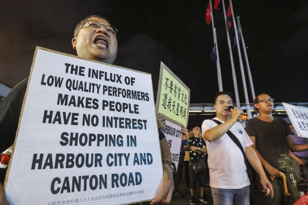 Protesters demonstrate against noisy singers at the Star Ferry Pier on Victoria Harbour in Tsim Sha Tsui. Photo: Felix Wong