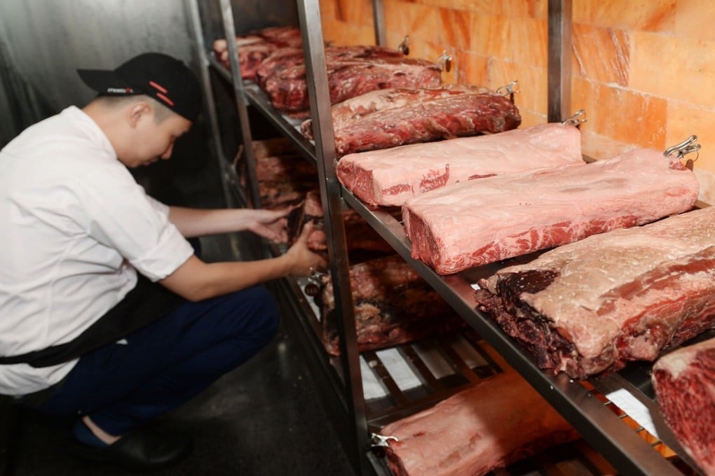 A staff member at upscale Stone Sal restaurant in Shanghai checks beef imported from the United States. Photo: AFP