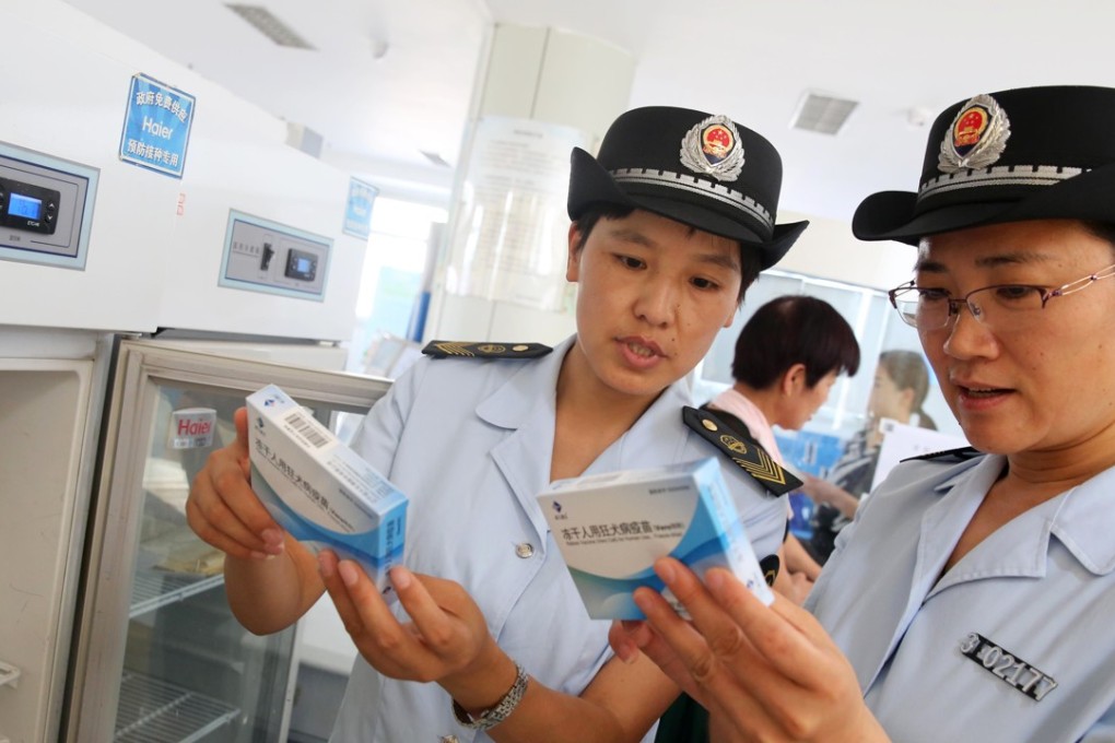 Officials from China’s food and drug administration carry out checks at a vaccines production facility. Photo: AFP