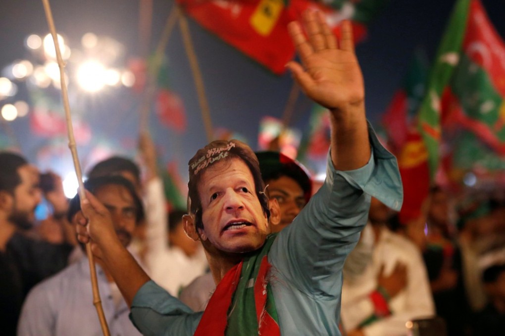 A Tehreek-e-Insaf supporter at a campaign rally in Karachi. Photo: Reuters
