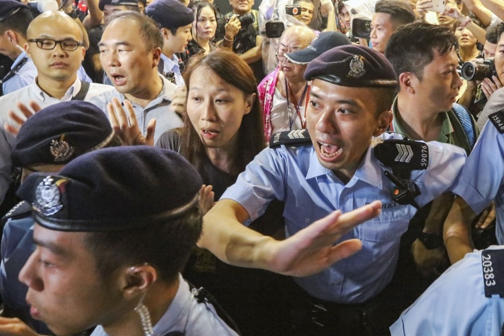 Police officers calm the situation at the Star Ferry pier. Photo: Felix Wong