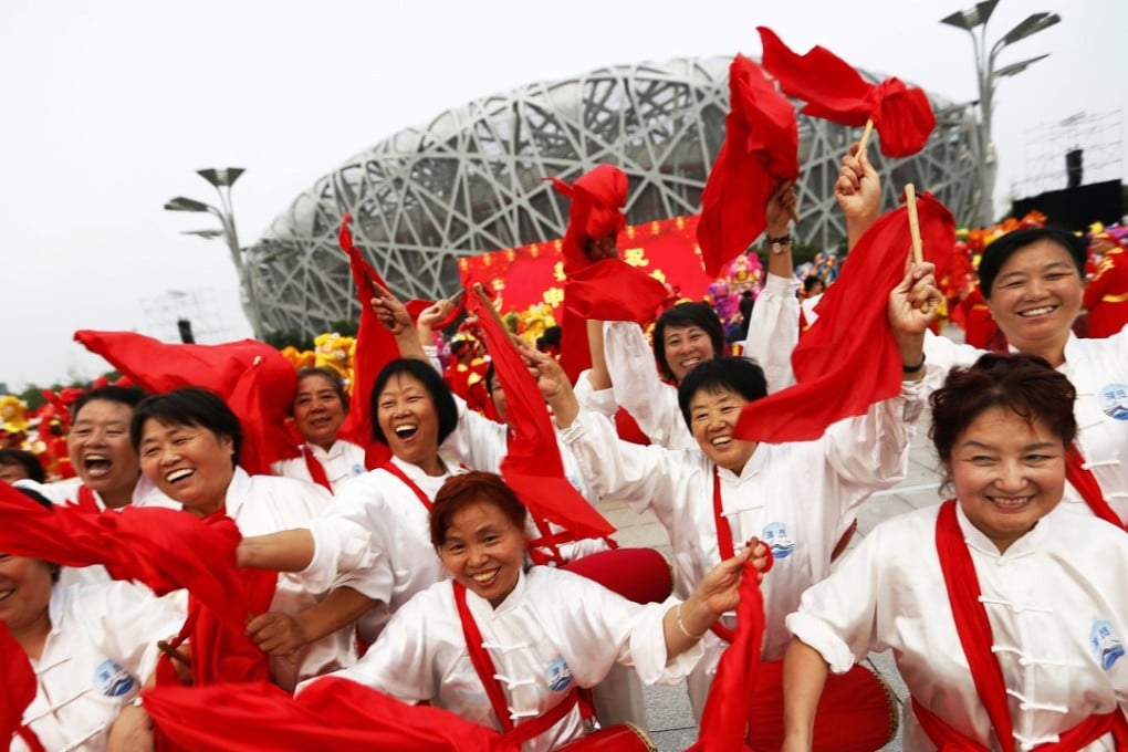 People celebrate following the announcement of Beijing winning the rights to host the 2022 Olympic Winter Games in front of the National Stadium in Beijing in July 2015. Photo: EPA