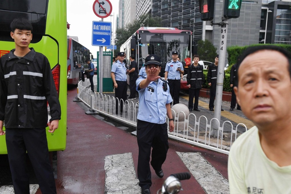 Police stand in front of the China Banking Regulatory Commission last Monday. Hundreds of police swarmed the streets of Beijing’s financial district on August 6 as a planned protest over P2P lending was quashed. Photo: AFP