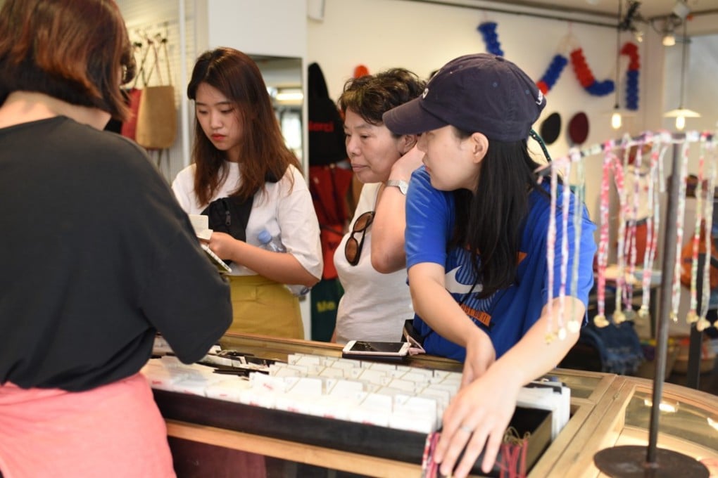 Chinese tourists shopping in Merci in Paris. Chinese millennials love the Merci-engraved medallion bracelets (a gold pendant on red thread) at this concept store with Chinese-speaking staff. Photo: Tamara Thiessen