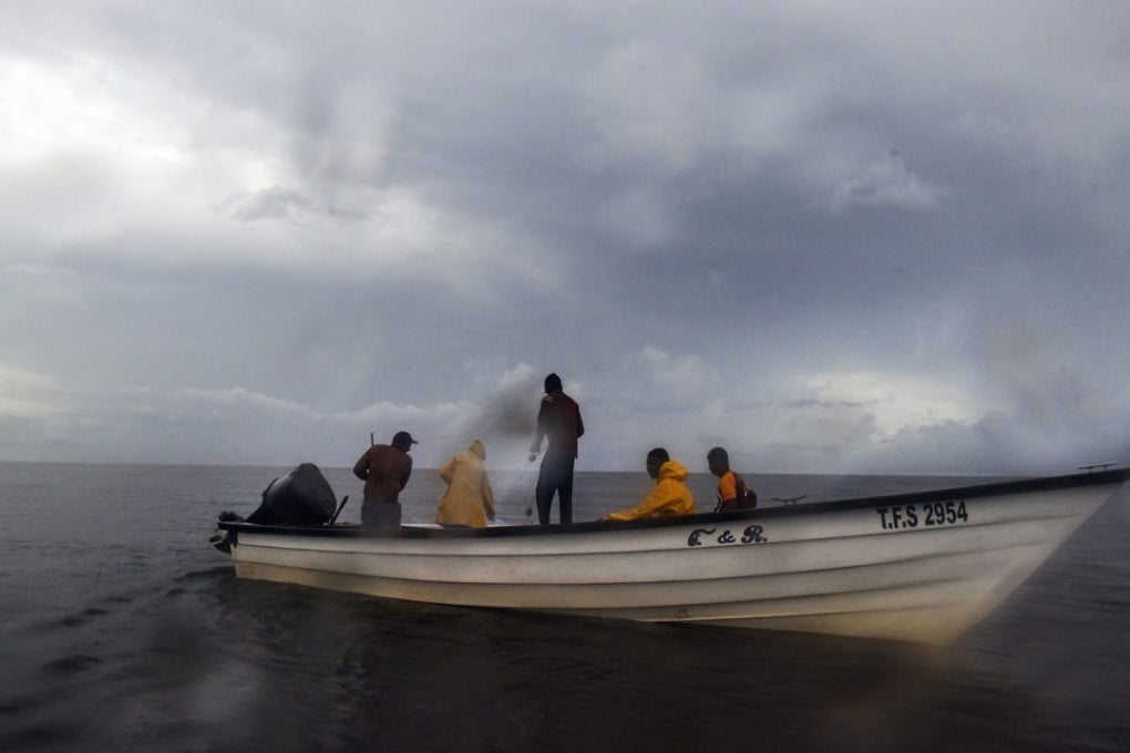 Fishermen work the waters between Venezuela and Trinidad where some have been either robbed and/or killed by Venezuelan pirates. Photo: Washington Post photo by Jahi Chikwendiu
