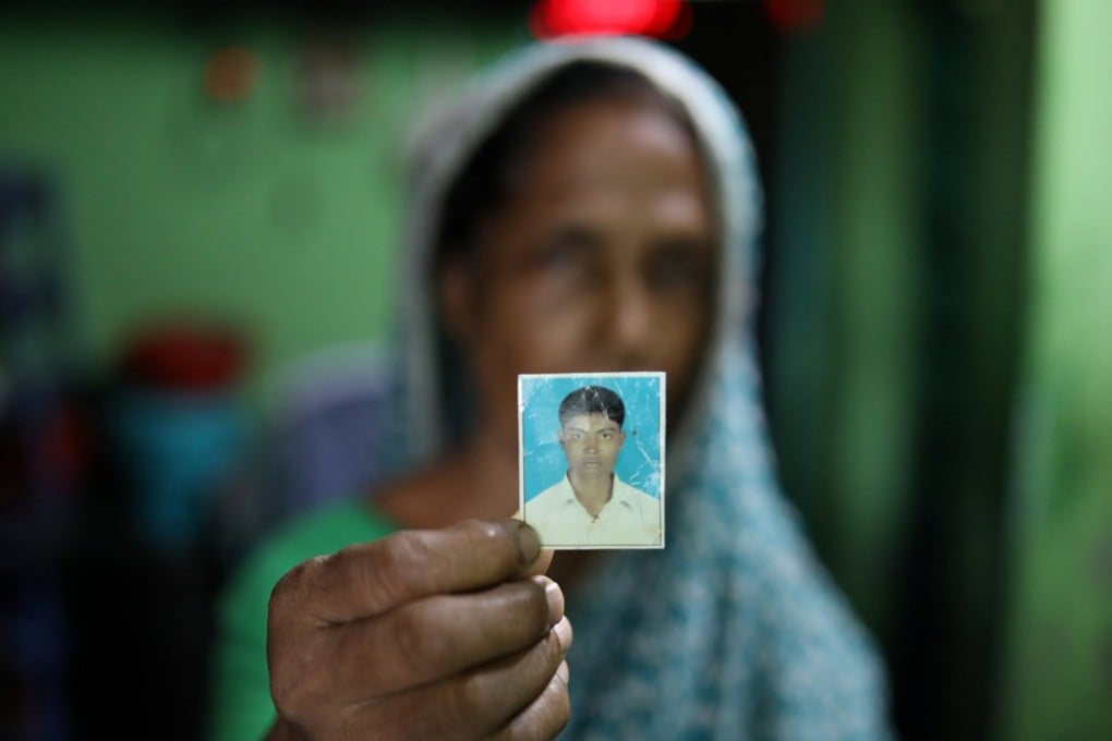 Rina Begum holds a photograph of her son Riazul Islam, an alleged drug dealer who was killed by police. Photo: Reuters