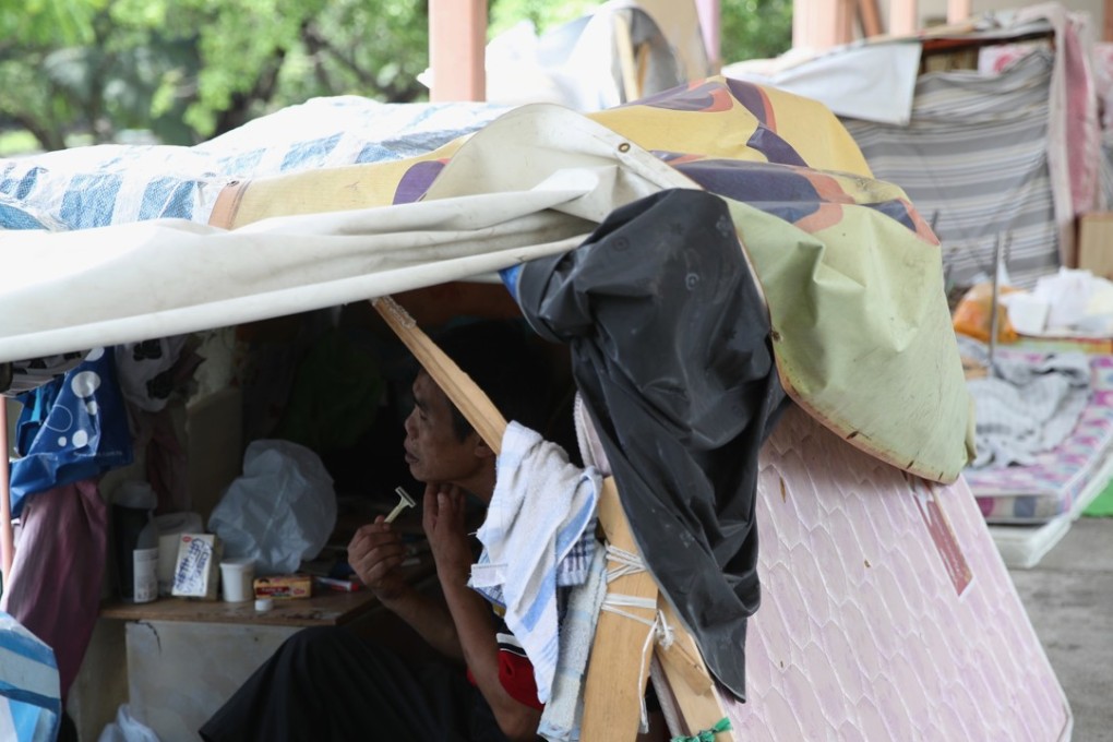 A homeless man shaves in his makeshift shack in Sham Shui Po on June 21. Photo: Edward Wong