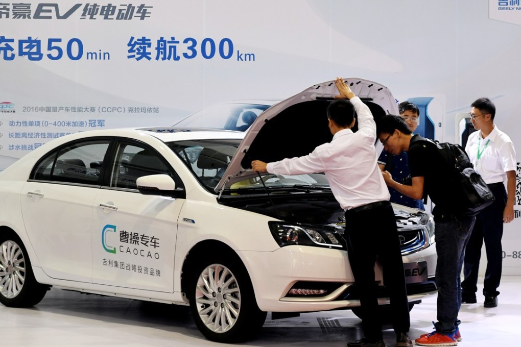 Men look at an electric car from Caocao Zhuanche, a chauffeur ride-hailing platform backed by Zhejiang Geely Holding Group, at a new energy vehicle trade fair in Zhengzhou, Henan province. Photo: Reuters