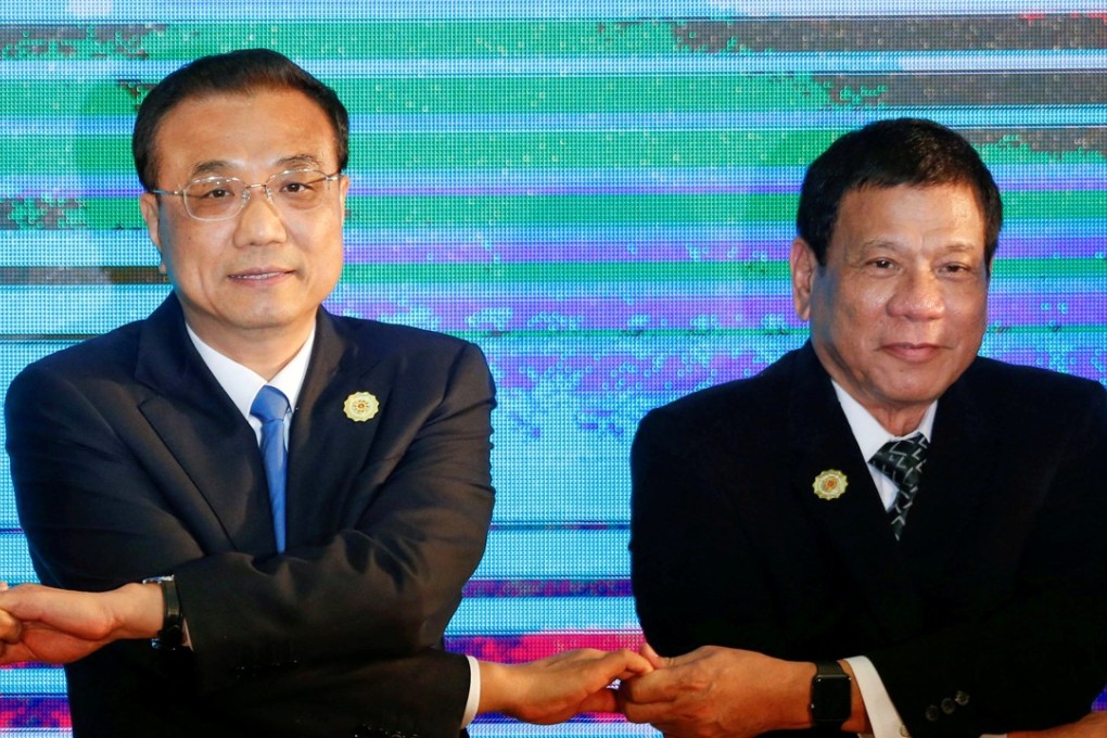 Chinese Premier Li Keqiang and Philippines President Rodrigo Duterte link hands while posing for a photo during the Asean Plus Three Summit in Vientiane, Laos, in September 2016. Photo: Reuters