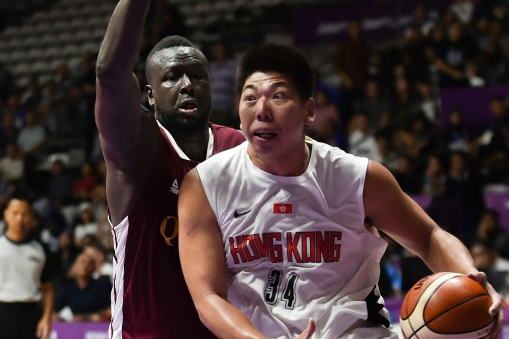Hong Kong's Szeto Wai-kit manoeuvres past Qatar's Mohd Mohammed during their group C game at the Asian Games in Jakarta. Photos: AFP