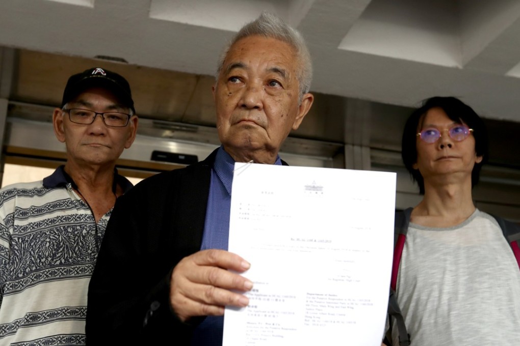 Former civil servant Kwok Cheuk-kin (centre) holding the judgment for his judicial review application on Tuesday. Photo: Nora Tam