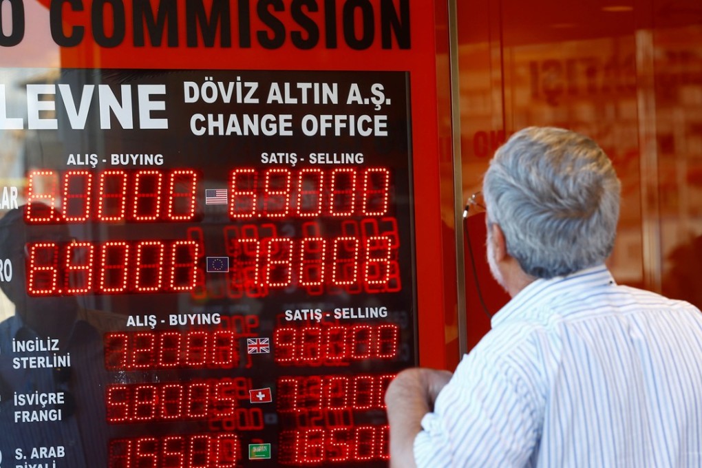 A man checks the display board of a currency exchange in Istanbul, Turkey, on August 13. The Turkish currency lost almost 20 per cent of its value against the US dollar last week. Photo: Reuters