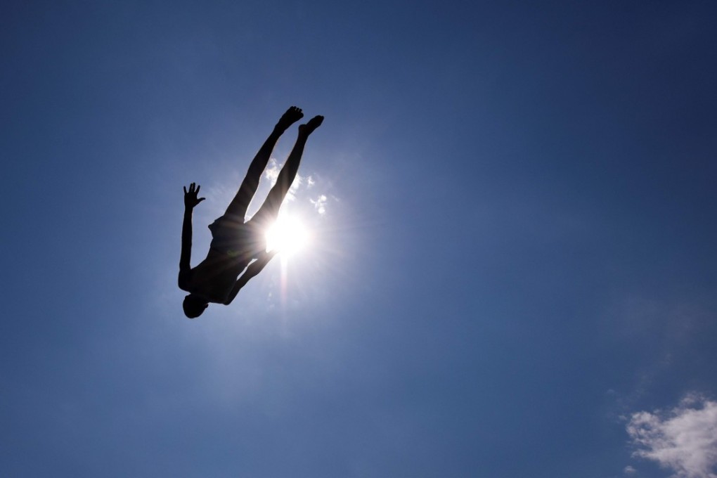 A man jumps into the lake near the town of Gjakova on August 12 as a heatwave sweeps across Europe. Photo: Agence France-Presse