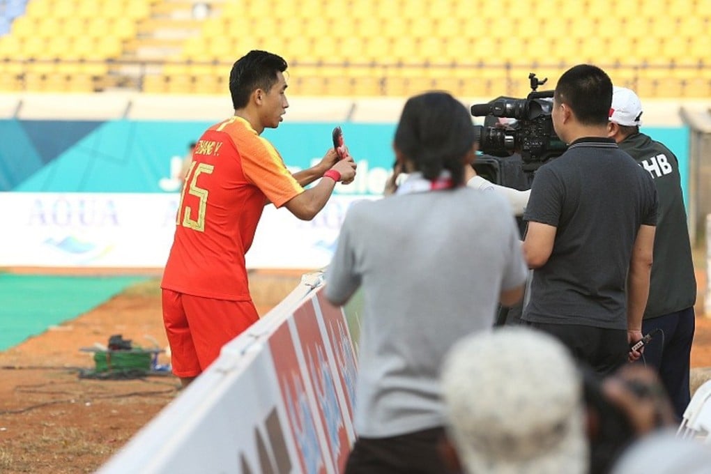 China's Zhang Yuan shows his shin guard to the camera after scoring in his side’s 6-0 Asian Games win over East Timor. Photo: Dongqiudi