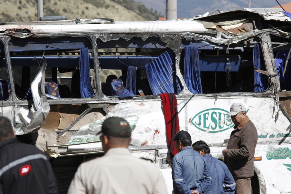Rescuers attend a Colombian-registered bus travelling to Quito, Ecuador, that crashed on Tuesday. Photo: AP