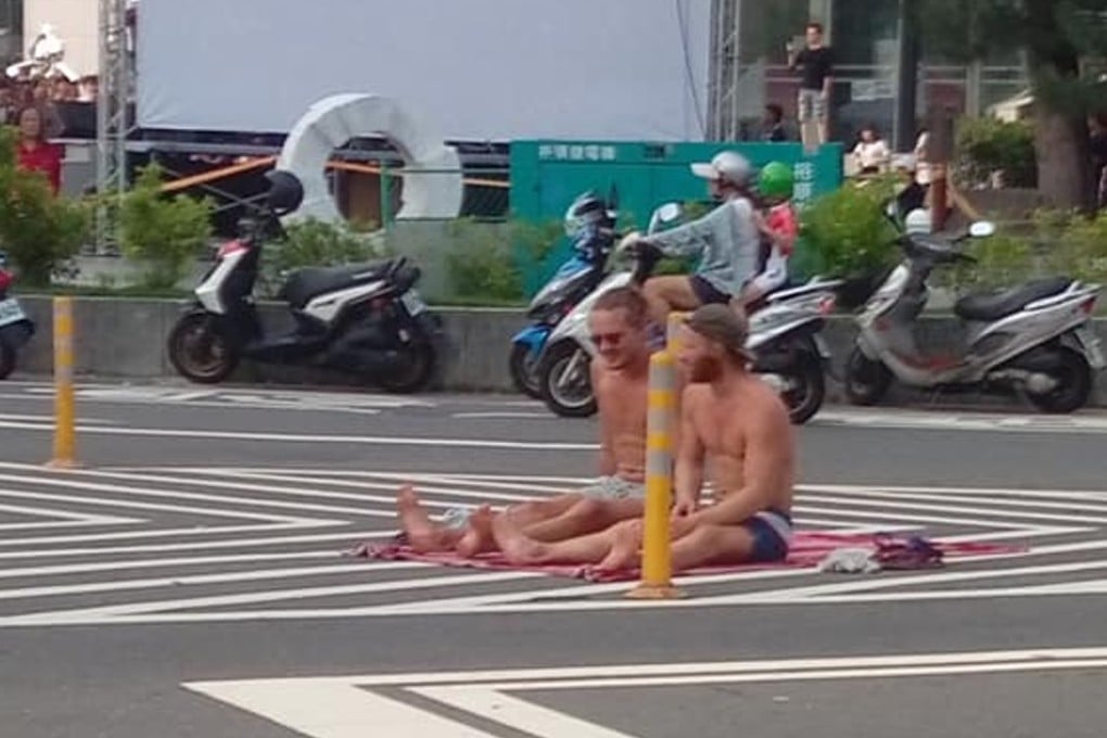 Two men were caught on camera sunbathing on a road in Taiwan. Source: Facebook