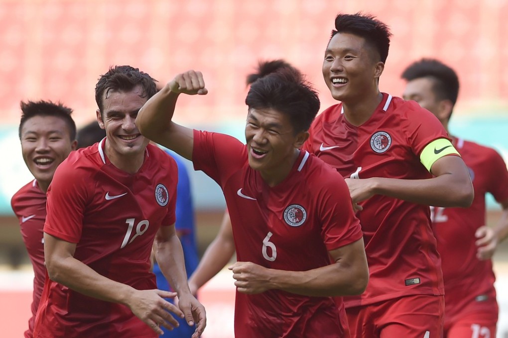 Tan Chun-lok of Hong Kong (centre) celebrates scoring against Taiwan. Photo: AFP