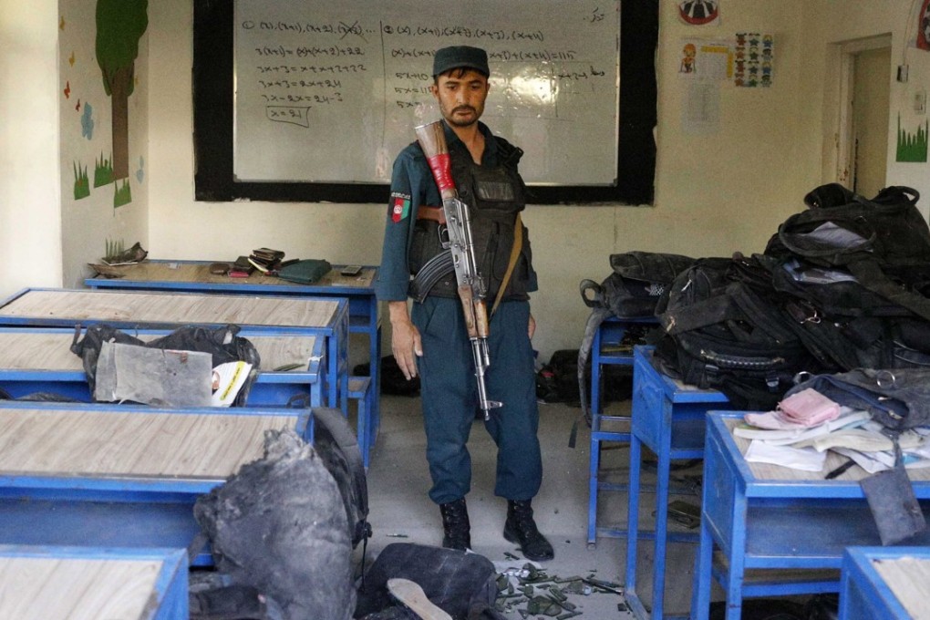 Afghan security officials inspect the scene of a suicide bomb attack in Kabul. Photo: EPA