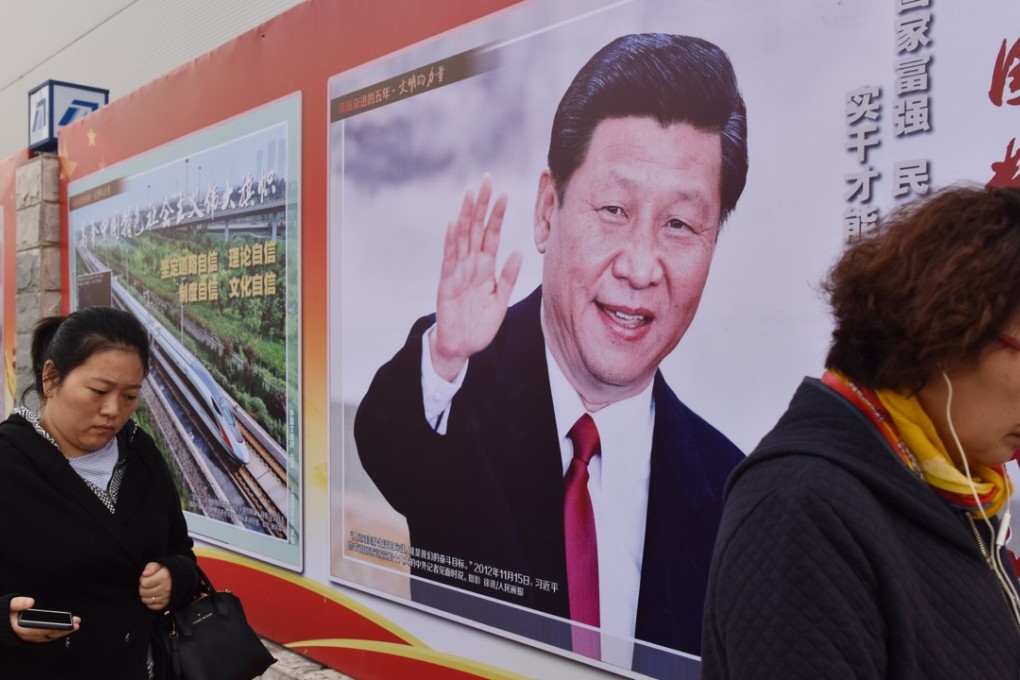 People walk past a poster featuring Chinese President Xi Jinping with a slogan reading "Chinese Dream, People's Dream" in Beijing. Xi’s medium-to-long-term plans, in particular its plan to move up the value chain and compete directly with the US in manufacturing through the Made in China 2025 campaign, are the true targets of the US trade war, rather than trade imbalances. Photo: AFP