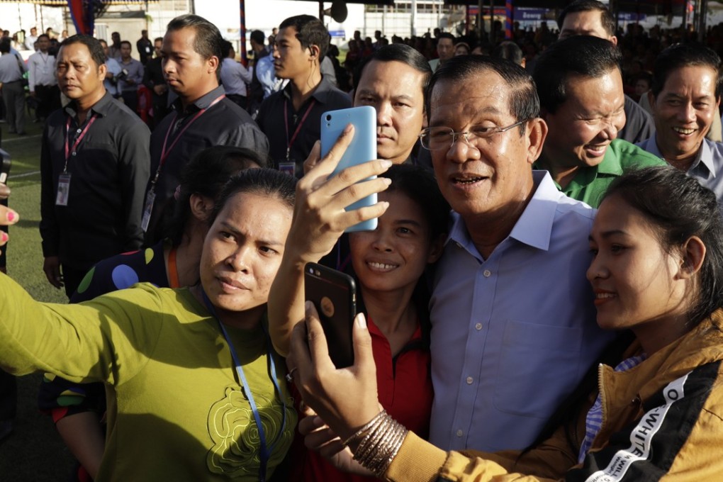 Cambodian Prime Minister Hun Sen (centre) poses for pictures with garment workers during an event in Phnom Penh on August 2. Photo: EPA
