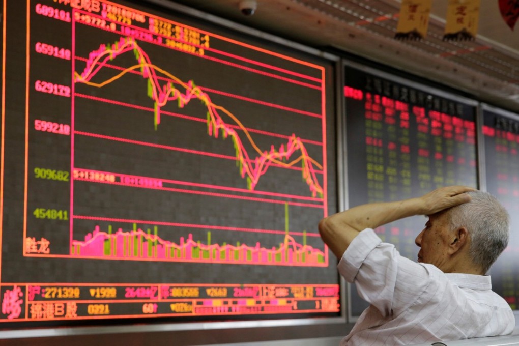 An investor looks at a board showing stock information at a brokerage office in Beijing on July 6. The Shanghai Composite Index entered a bear market in late July. Photo: Reuters