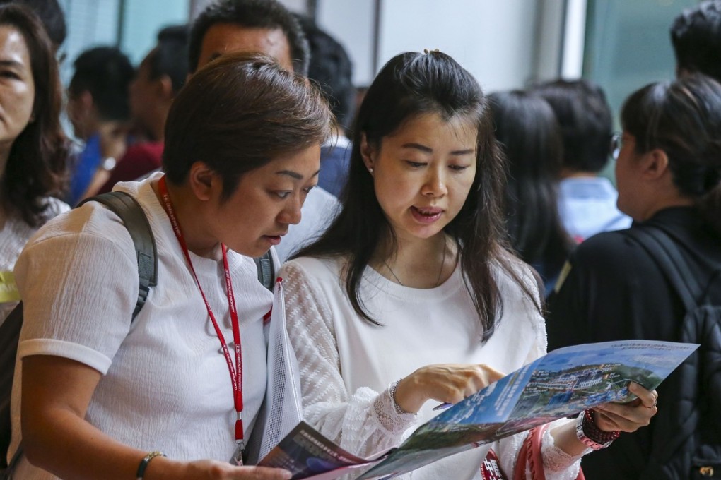 Potential buyers queue up for SHKP's residential project St Martin at the International Commerce Centre (ICC) in West Kowloon on July 14, 2018. Photo: SCMP