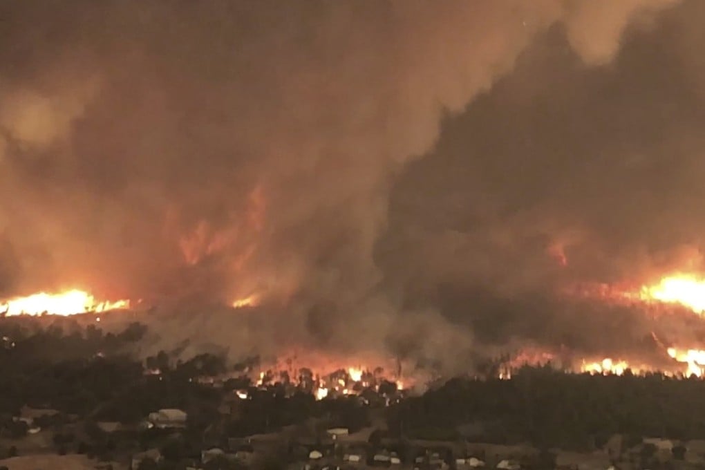 This July 26, 2018 image from video released by Cal Fire shows a fire tornado over Lake Keswick Estates near Redding, California. Photo: AP