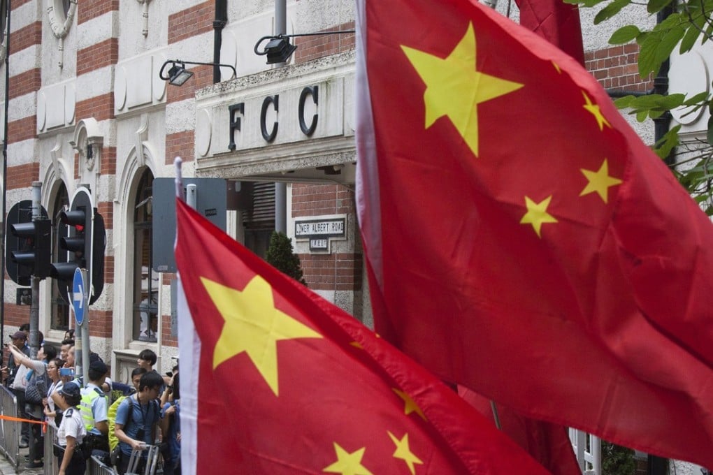 China’s flags fly as opponents of Hong Kong independence gather outside the Foreign Correspondents’ Club on August 14 to protest against the talk by independence advocate Andy Chan Ho-tin. Photo: EPA-EFE