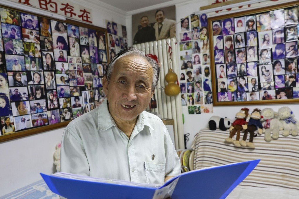 Zhu Fang browses through his files in a Beijing flat filled with photos of Chinese singles. Photo: Simon Song