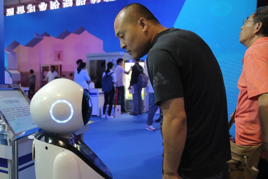A visitor observes a robot on display at the 21st China Beijing international hi-tech expo on May 17. Photo: EPA-EFE