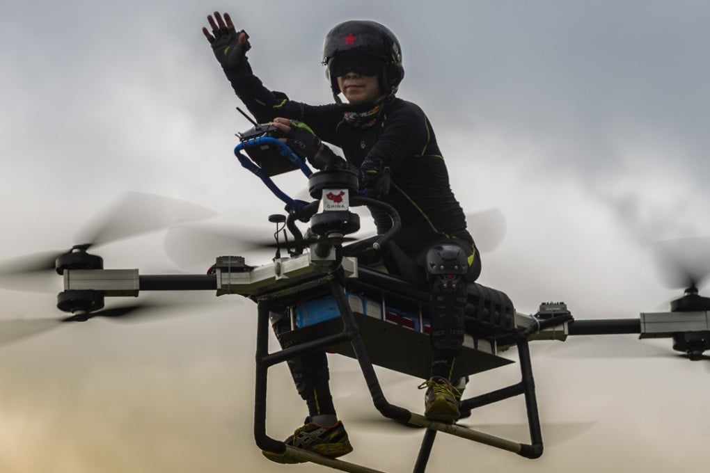 Zhao Deli waves to spectators as he pilots his self-made “flying scooter” in Dongguan. Photo: EPA-EFE