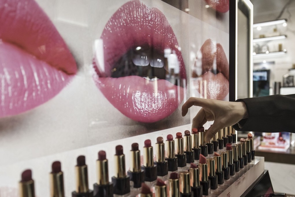 A shop assistant arranges lipsticks at a mall in Shanghai. Photo: Bloomberg