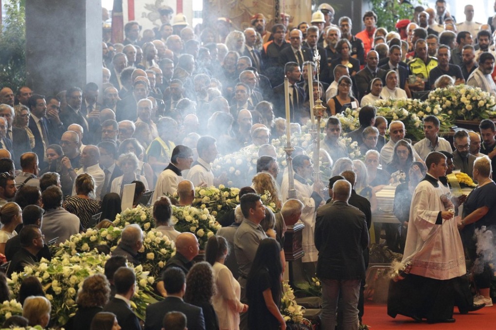 A funeral service for some of the victims of a collapsed highway bridge in Genoa. Photo: AP