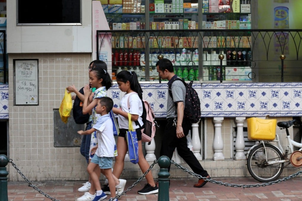 A family in Macau heads towards the border with mainland China. Photo: Raquel Carvalho