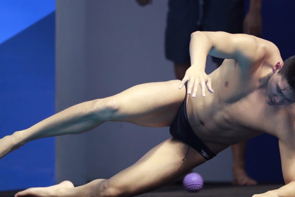 Singapore's Joseph Schooling performs some stretching exercises ahead of racing at the Jakarta Aquatic Centre. Photo: AP