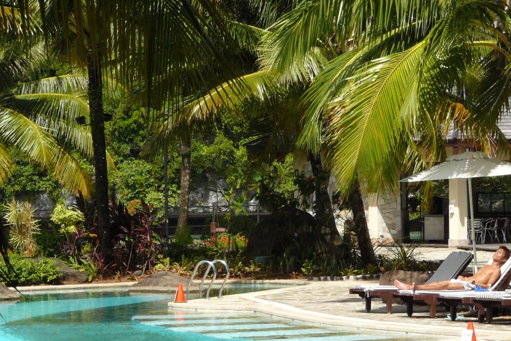 A lone tourist sunbathes by a swimming pool in Palau earlier this year. Photo: EPA-EFE
