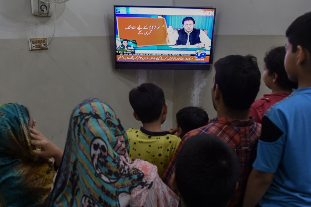 A family watching the speech of newly appointed Pakistani Prime Minister Imran Khan in Lahore on Sunday. Khan said the country was in its worst economic condition and pledged to improve it by adopting austerity measures to cut government expenditures. Photo: AFP